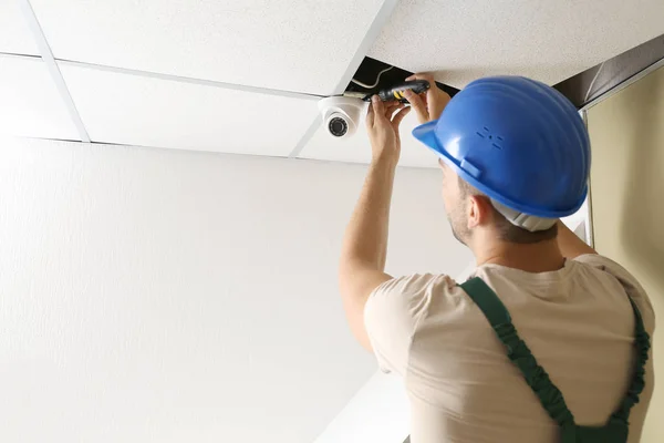 Electrician installing alarm system indoors — Stock Photo, Image