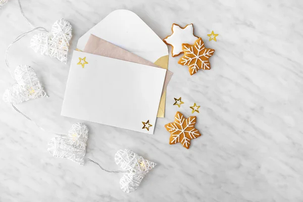 Empty greeting card with envelope and Christmas cookies on white background — Stock Photo, Image
