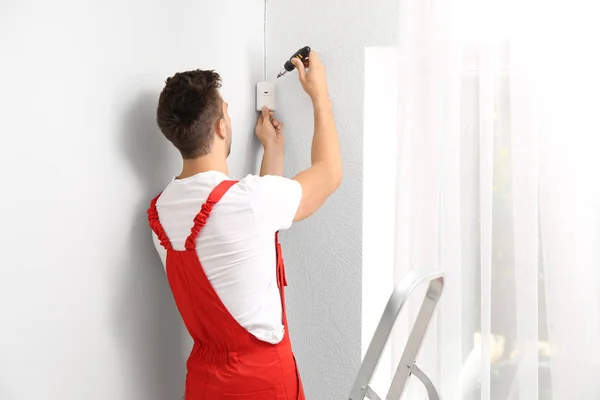 Electrician installing alarm system indoors — Stock Photo, Image