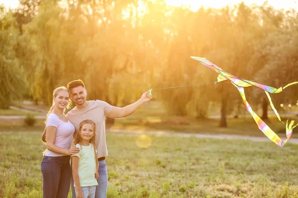 Happy family flying kite outdoors — Stock Photo, Image