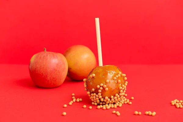 Tasty candy apple on color background — Stock Photo, Image