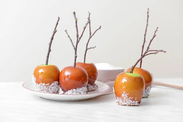 Tasty candy apples on light table — Stock Photo, Image