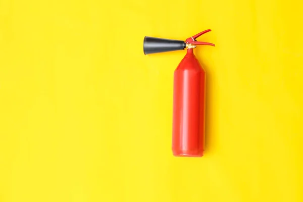 Fire extinguisher on color background — Stock Photo, Image