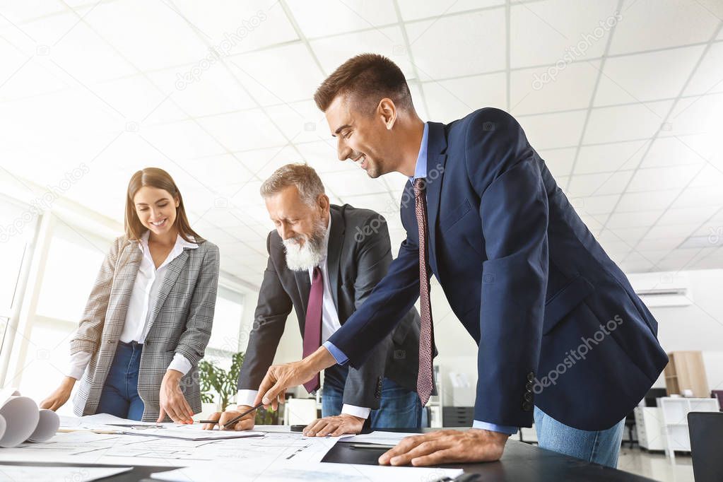 Team of architects discussing project in office