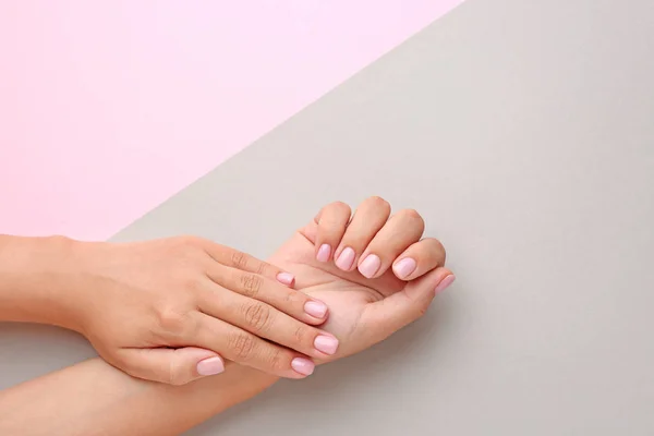 Female hands with beautiful manicure on color background — Stock Photo, Image