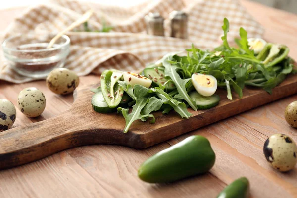 Board with tasty salad on wooden table — Stock Photo, Image