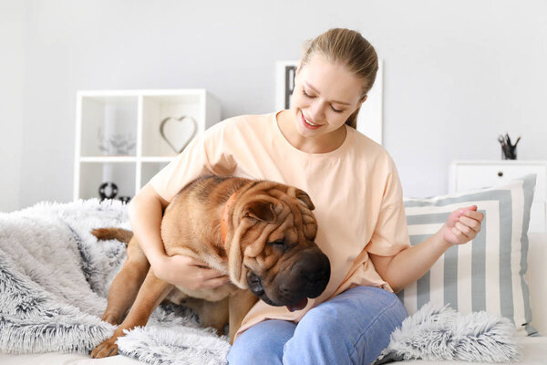 Happy woman with cute dog at home