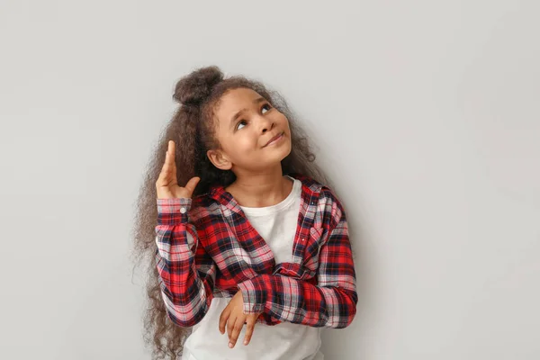 African-American girl on light background — Stock Photo, Image