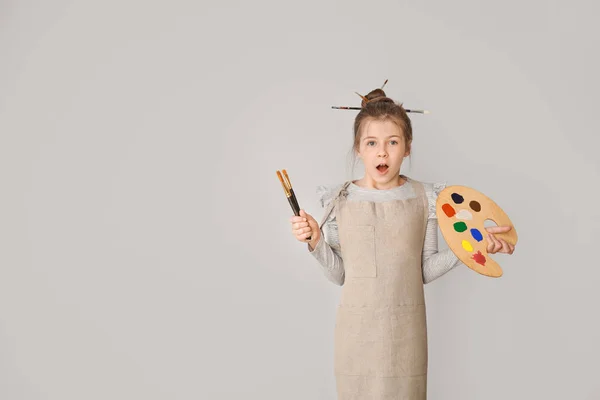 Surprised little artist on light background — Stock Photo, Image