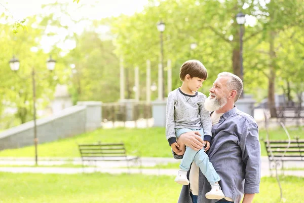 Söt liten pojke med farfar i parken — Stockfoto