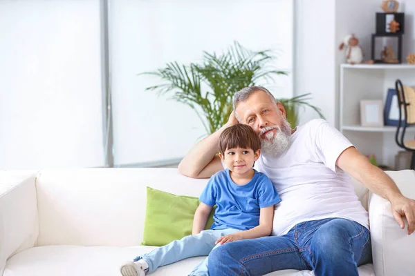 Cute little boy with grandfather at home — Stock Photo, Image
