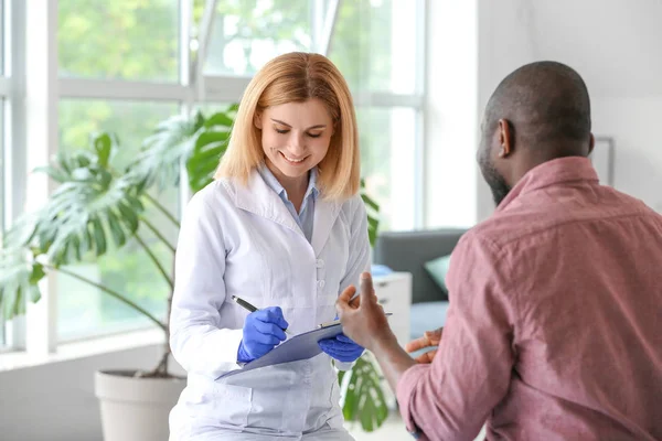 Afrikaans-Amerikaanse man ontmoeting met plastisch chirurg in kliniek — Stockfoto