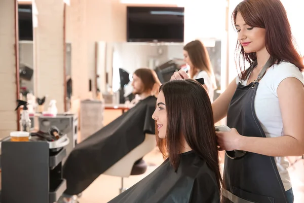 Peluquería femenina trabajando con el cliente en el salón —  Fotos de Stock