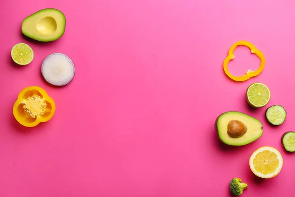 Fresh avocado, fruits and vegetables on color background — Stock Photo, Image