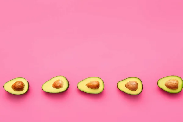 Helften van verse avocado's op kleur achtergrond — Stockfoto