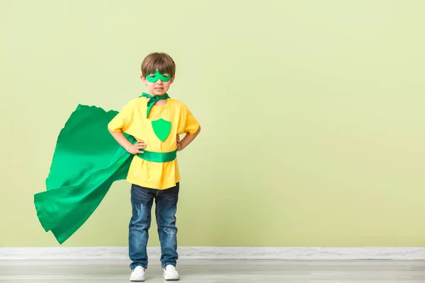 Cute little boy dressed as superhero near color wall — Stock Photo, Image