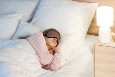 Genç kız geceleri yatakta uyuyor