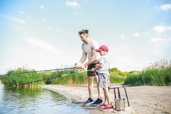 Father and son fishing together on river — Stock Photo, Image