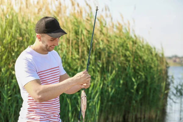 Junger Mann angelt auf Fluss — Stockfoto