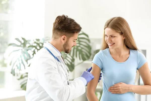 Läkare som vaccinerar gravida kvinnor på kliniken — Stockfoto