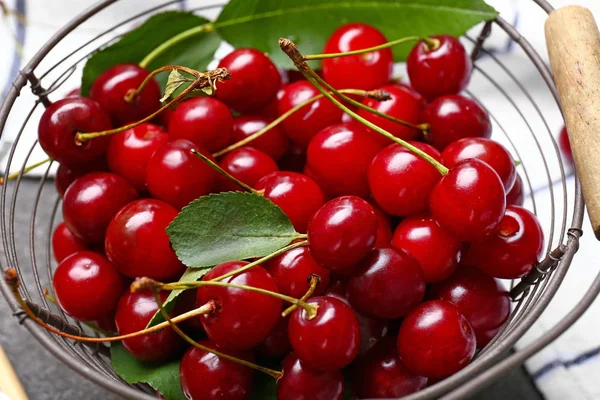 Basket with ripe sweet cherry on table, closeup