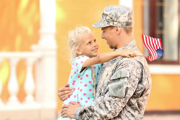 Happy military man with his daughter outdoors