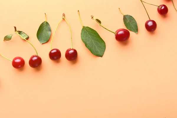 Many ripe sweet cherry on color background — Stock Photo, Image