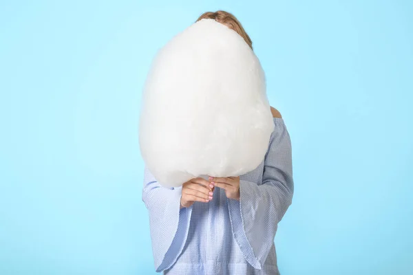 Young woman with tasty cotton candy on color background — Stock Photo, Image