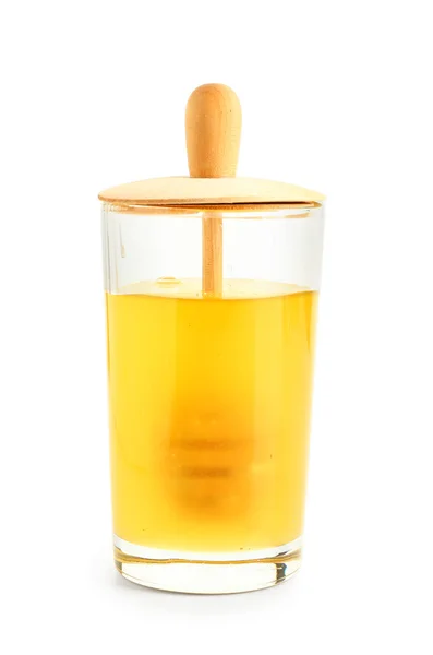 Glass container with fresh honey on white background — Stock Photo, Image