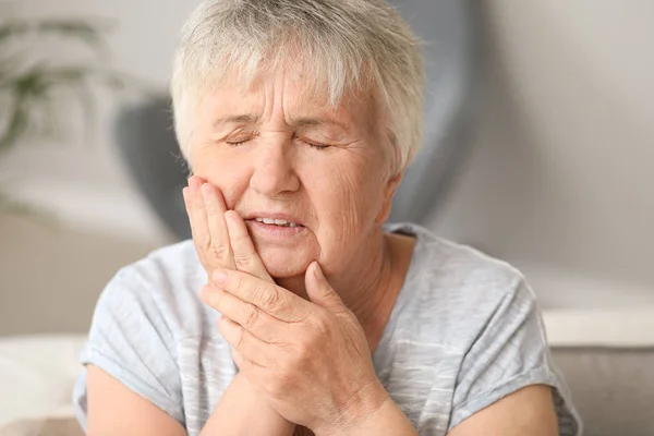 Senior woman suffering from toothache at home — Stock Photo, Image