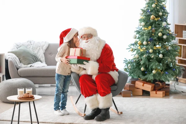 Little girl telling Santa her wish in room decorated for Christmas — Stock Photo, Image