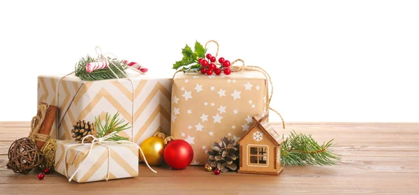 Beautiful Christmas gifts on wooden table against white background — Stock Photo, Image