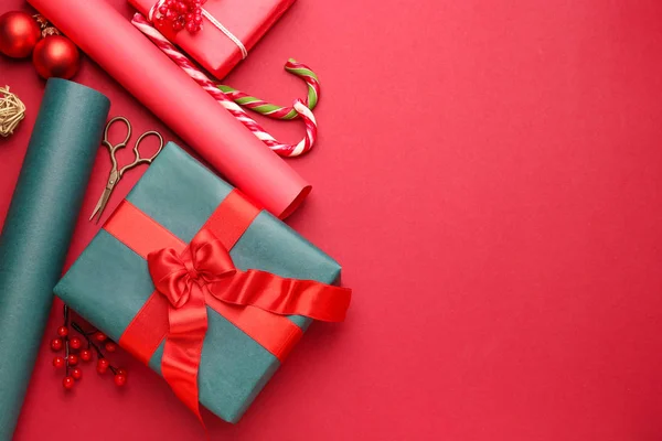 Christmas gift box with wrapping paper on color background — Stock Photo, Image