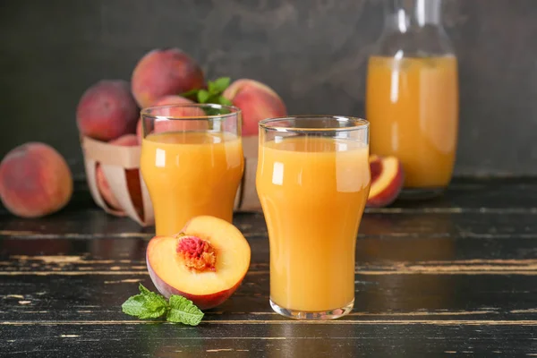 Glasses of tasty peach juice on wooden table — Stock Photo, Image