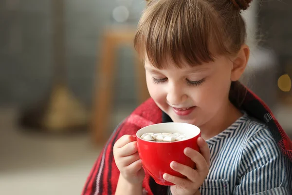 Cute little girl drinking hot chocolate at home on Christmas eve — Stock Photo, Image