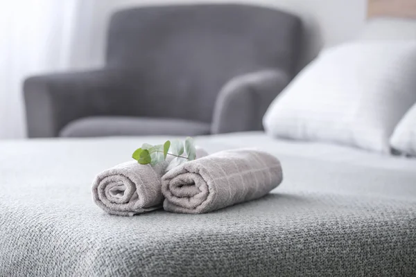 Rolled clean towels on bed — Stock Photo, Image
