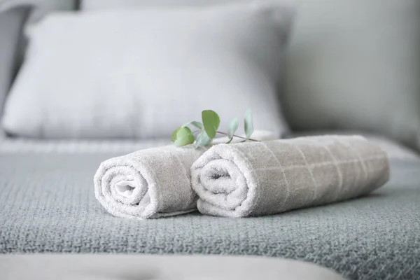 Rolled clean towels on bed — Stock Photo, Image