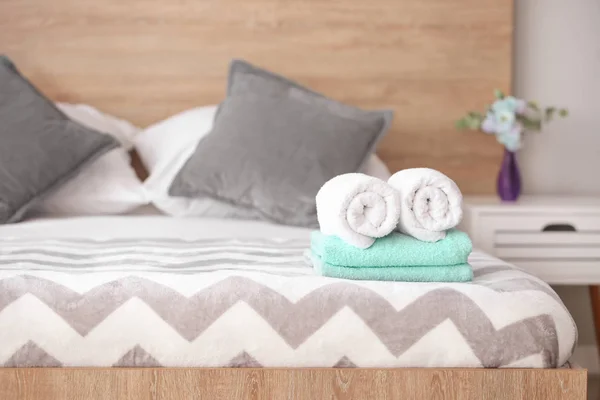 Soft clean towels on bed — Stock Photo, Image