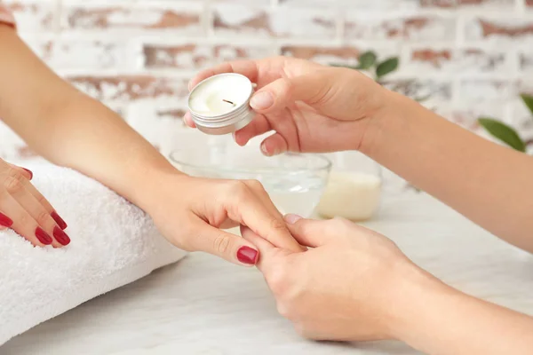 Woman receiving massage with aroma candle in spa salon — Stock Photo, Image