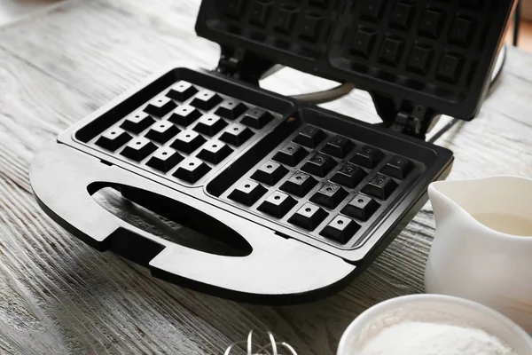 Modern waffle maker on wooden table — Stock Photo, Image