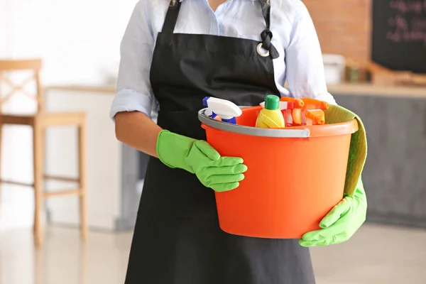 Woman with cleaning supplies in kitchen, closeup — Stock Photo, Image