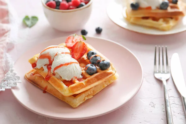 Plate with tasty sweet waffles, ice cream and berries on table — Stock Photo, Image