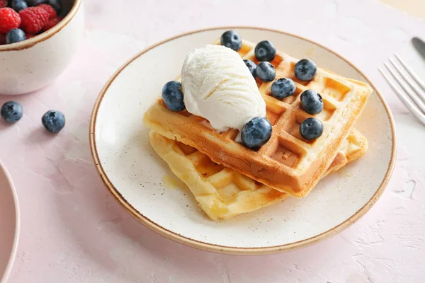 Plate with tasty sweet waffles, ice cream and blueberry on table — Stock Photo, Image
