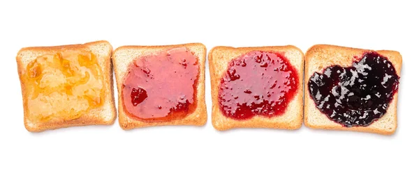 Tasty toasted bread with different jams on white background — Stock Photo, Image