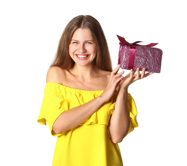 Happy young woman with gift on white background — Stock Photo, Image