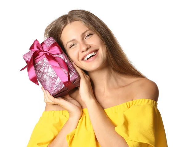 Happy young woman with gift on white background — Stock Photo, Image