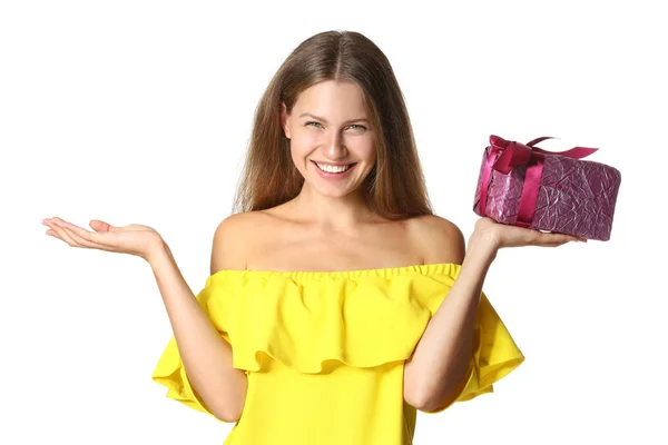Happy young woman with gift on white background — Stock Photo, Image
