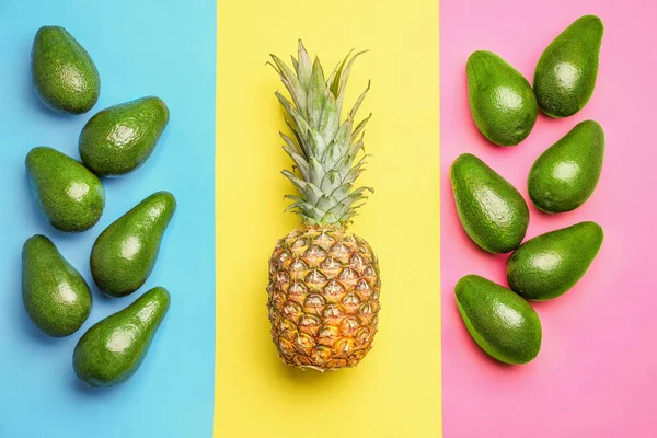 Fresh avocados and pineapple on color background — Stock Photo, Image