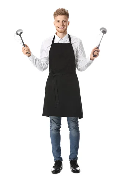 Bonito chef masculino com utensílios de cozinha sobre fundo branco — Fotografia de Stock