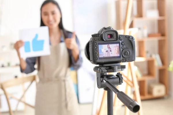 Female Asian blogger recording video in workshop — Stock Photo, Image